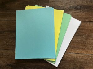Cardstock in blue, canary yellow, green, and white 